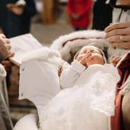 Perfect newborn baby sleeps during the baptism ceremony